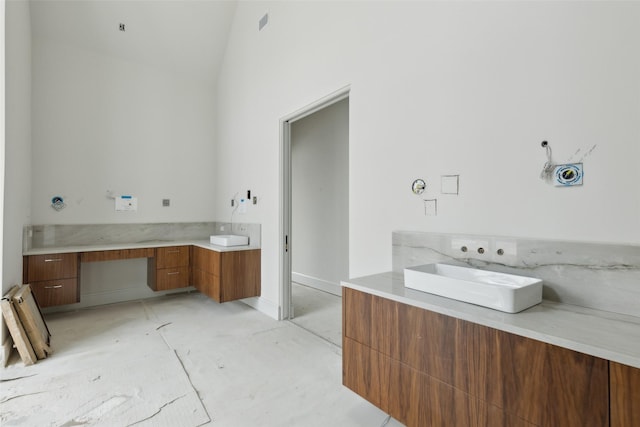 bathroom with lofted ceiling and sink