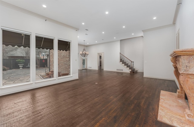 unfurnished living room featuring dark hardwood / wood-style flooring and ornamental molding