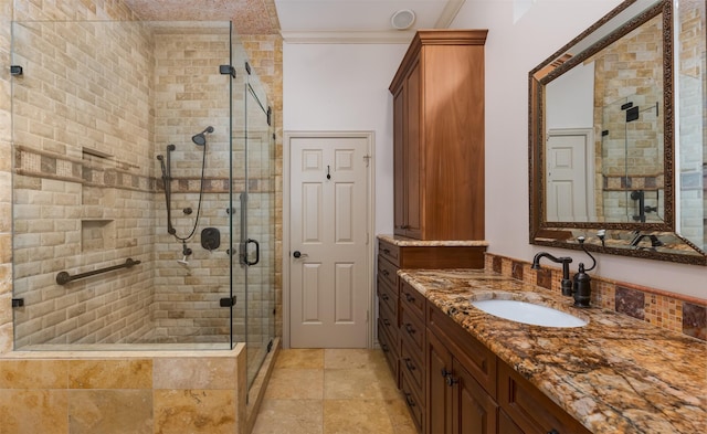 bathroom featuring an enclosed shower, vanity, and crown molding