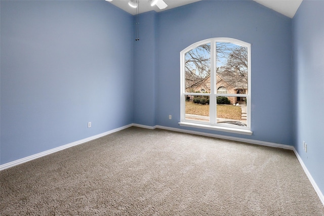 spare room with vaulted ceiling and carpet