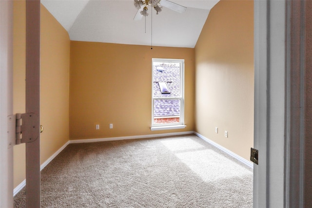 unfurnished room featuring carpet floors, vaulted ceiling, and ceiling fan