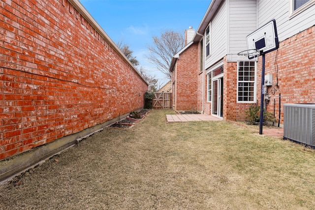 view of yard with cooling unit and a patio area