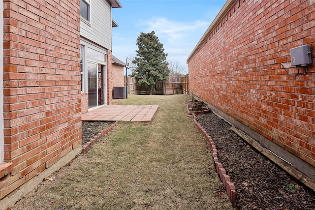 view of yard featuring a patio and central air condition unit