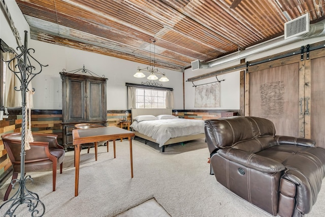 carpeted bedroom with a barn door