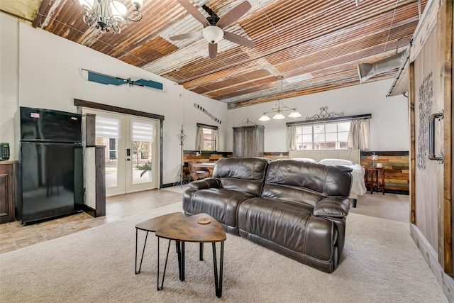 living room featuring light colored carpet, french doors, and ceiling fan