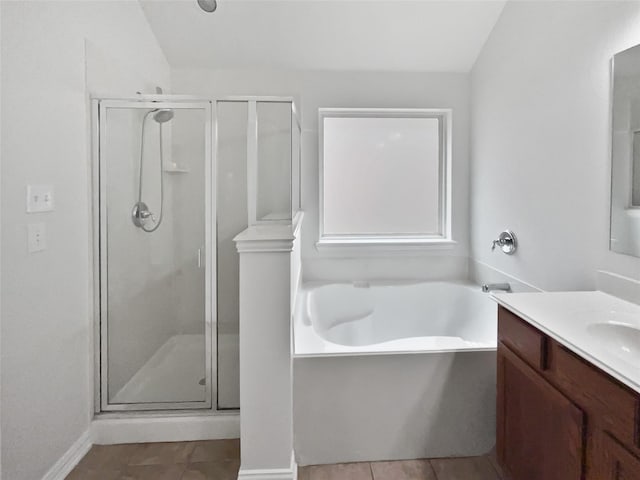 bathroom featuring vanity, shower with separate bathtub, and tile patterned floors