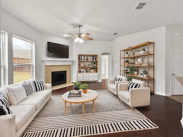 living room with dark wood-type flooring and ceiling fan