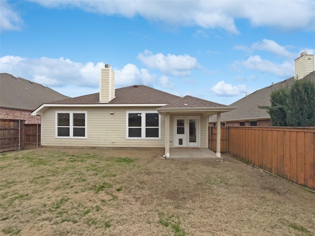 back of house featuring a patio and a lawn