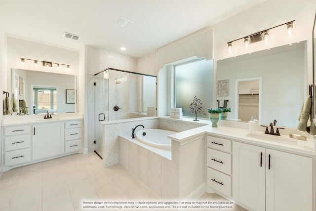 bathroom with tile patterned flooring, vanity, and plus walk in shower