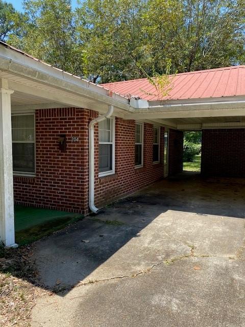 view of property exterior with a carport