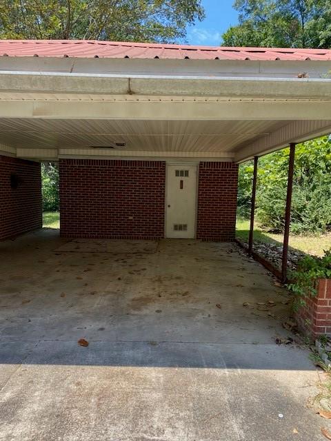 view of vehicle parking with a carport