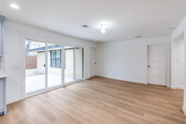 spare room with light hardwood / wood-style flooring