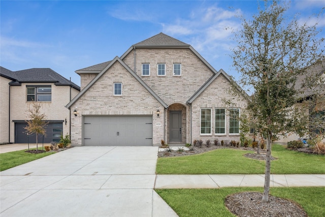 view of front facade with a garage and a front lawn