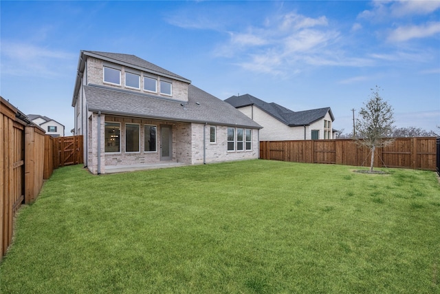 rear view of property featuring a yard