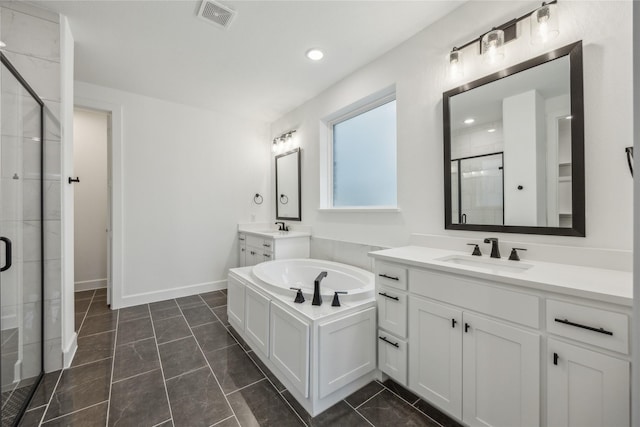 bathroom with tile patterned flooring, vanity, and walk in shower