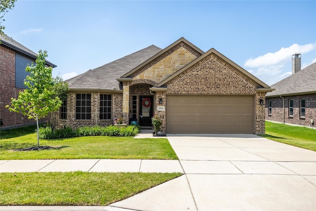 view of front of house with a garage and a front lawn