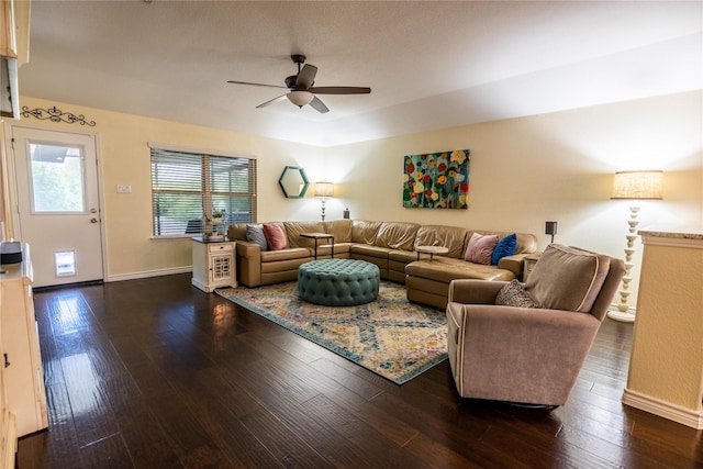 living room with dark hardwood / wood-style flooring and ceiling fan