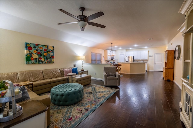 living room featuring dark wood-type flooring and ceiling fan