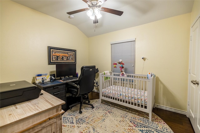 bedroom with a crib, vaulted ceiling, hardwood / wood-style floors, and ceiling fan