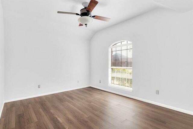 bedroom featuring dark hardwood / wood-style flooring, vaulted ceiling, and ceiling fan