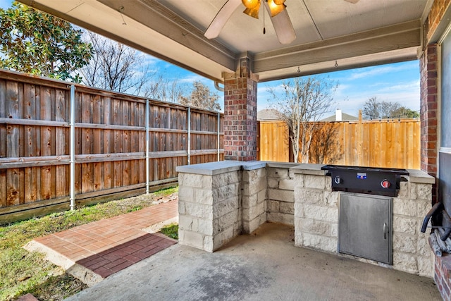 view of patio with ceiling fan and area for grilling