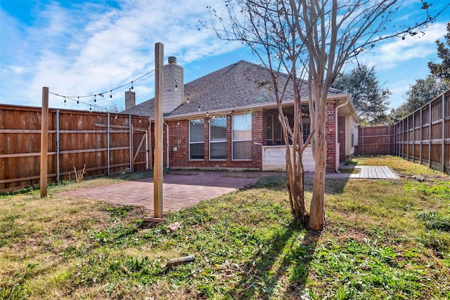 back of property with a patio area and a lawn