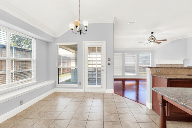 interior space with crown molding, lofted ceiling, hanging light fixtures, and light tile patterned floors