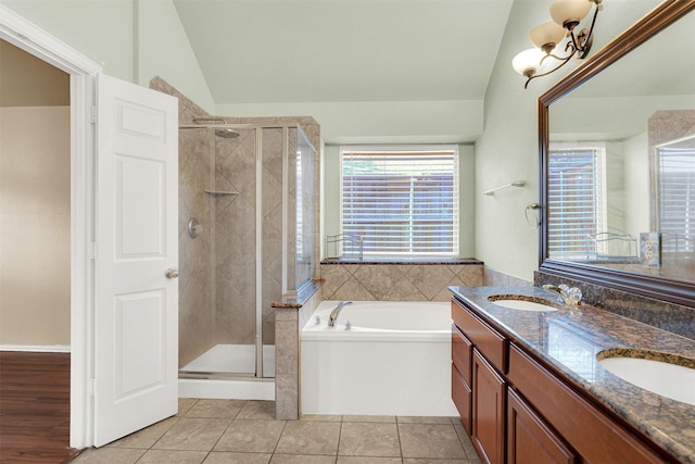 bathroom featuring lofted ceiling, vanity, tile patterned floors, and separate shower and tub