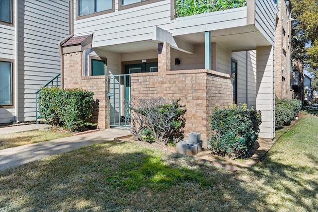 view of exterior entry with a lawn