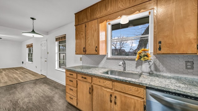 kitchen with sink, dishwasher, hanging light fixtures, dark hardwood / wood-style floors, and tasteful backsplash