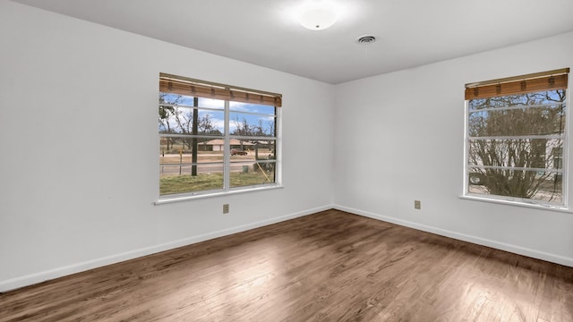 spare room with wood-type flooring