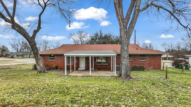 rear view of property with a patio area and a lawn