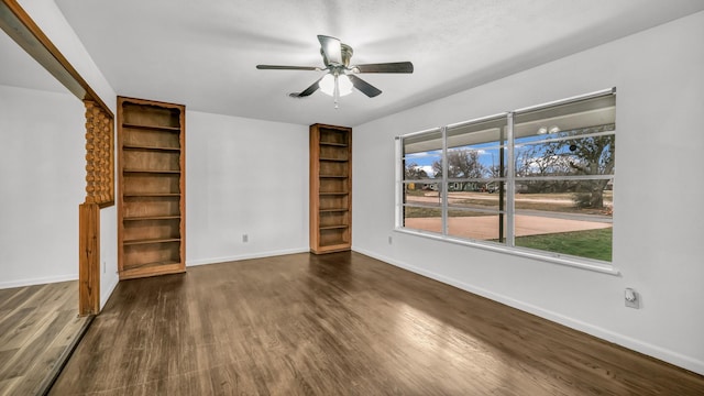 unfurnished living room with dark hardwood / wood-style floors and ceiling fan