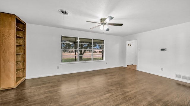 empty room featuring dark hardwood / wood-style floors and ceiling fan