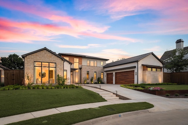 modern home with a garage and a lawn