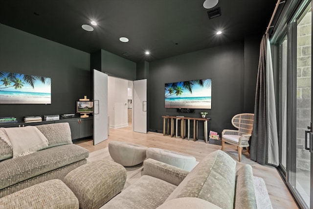 home theater room featuring light hardwood / wood-style floors