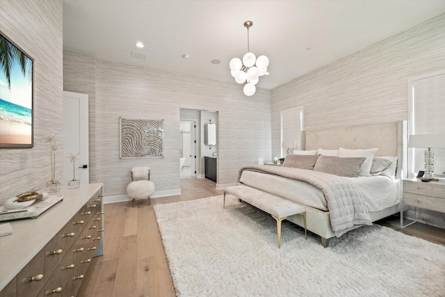 bedroom featuring wood-type flooring and a chandelier