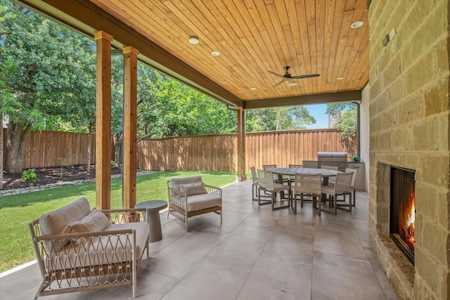 view of patio featuring an outdoor living space with a fireplace and ceiling fan