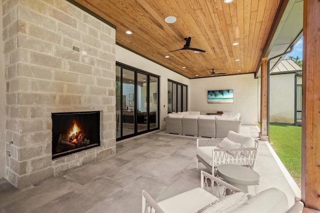 view of patio with an outdoor living space with a fireplace and ceiling fan