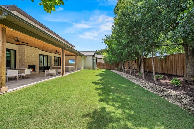 view of yard with ceiling fan and a patio area