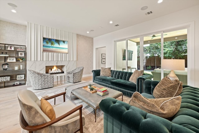 living room with a fireplace and light hardwood / wood-style flooring