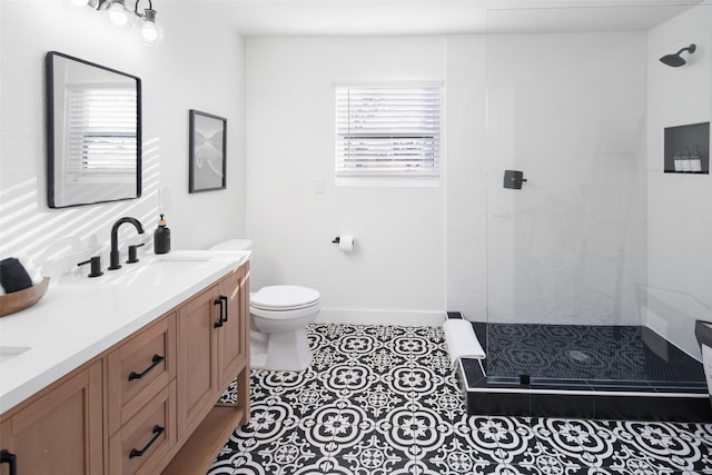 bathroom with toilet, vanity, tile patterned floors, and walk in shower