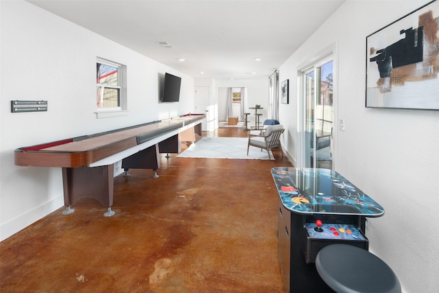 recreation room with a wealth of natural light and concrete floors