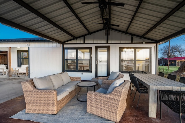 sunroom featuring lofted ceiling and ceiling fan