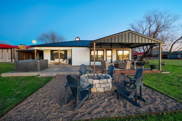 rear view of house with an outdoor living space, a yard, and a patio