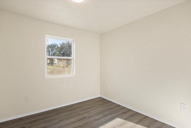 spare room featuring dark hardwood / wood-style flooring