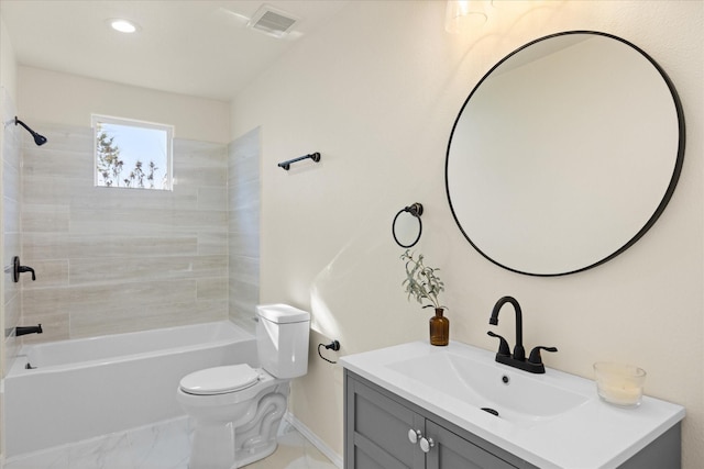 full bathroom with vanity, tiled shower / bath combo, and toilet