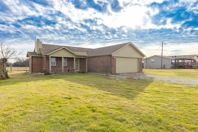 single story home featuring a garage and a front yard