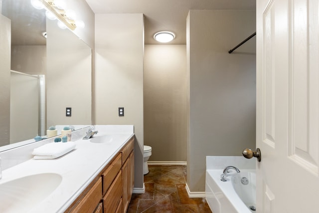 bathroom with vanity, a bath, and toilet