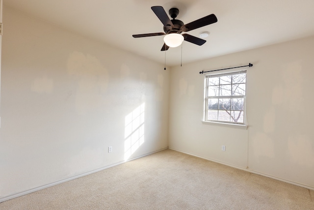 unfurnished room featuring light carpet and ceiling fan